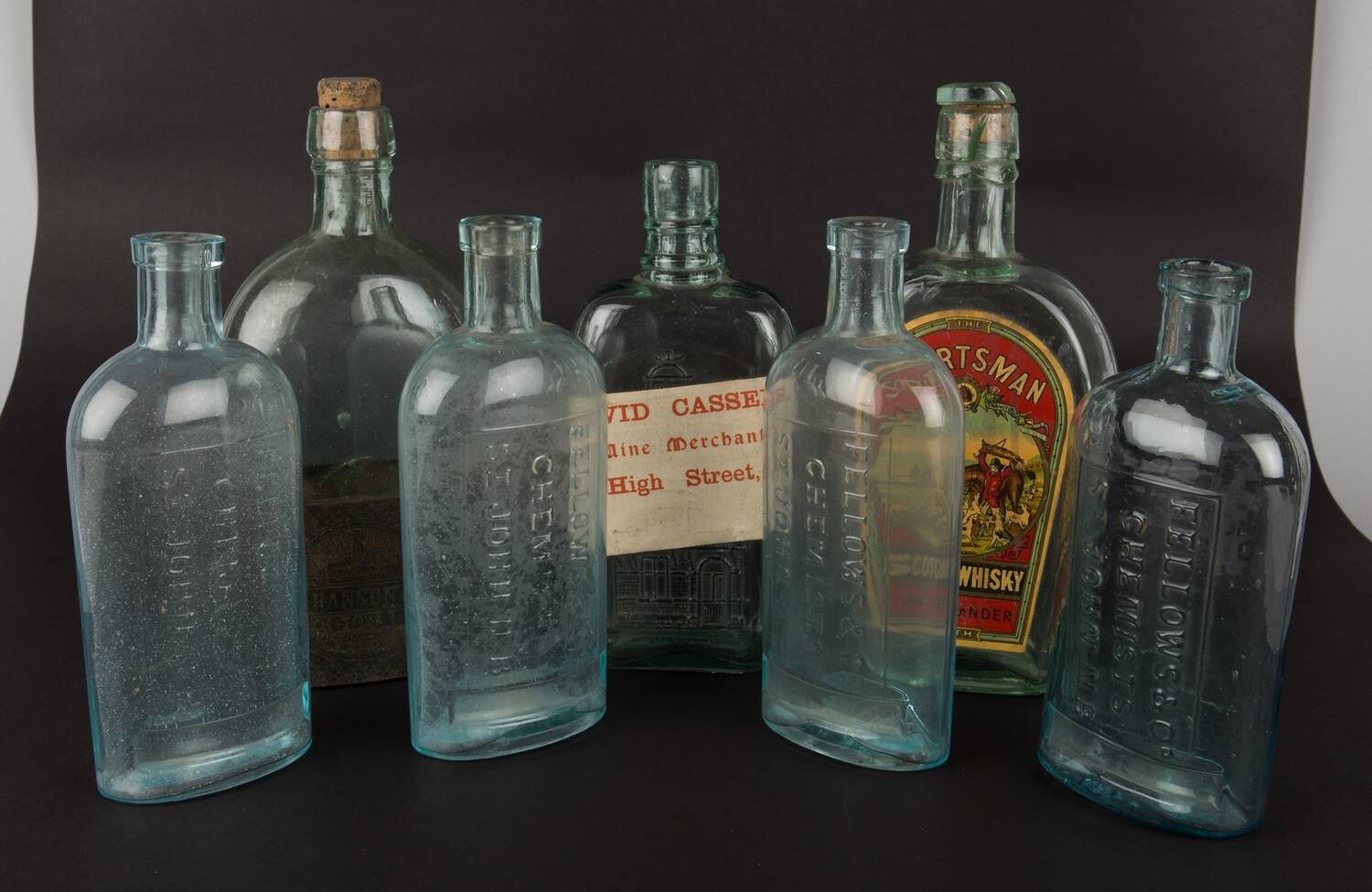 A row of empty old whisky bottles on display at Robert Burns Birthplace Museum