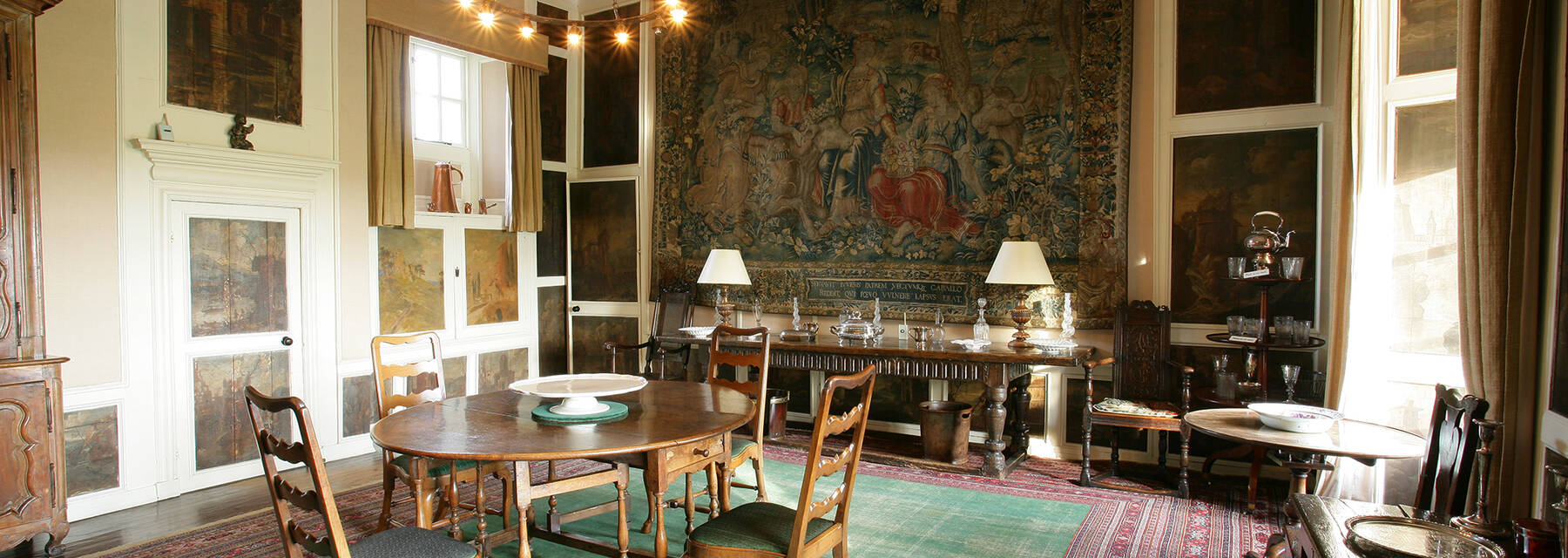 Kellie Castle dining room with wall tapestry and paintings