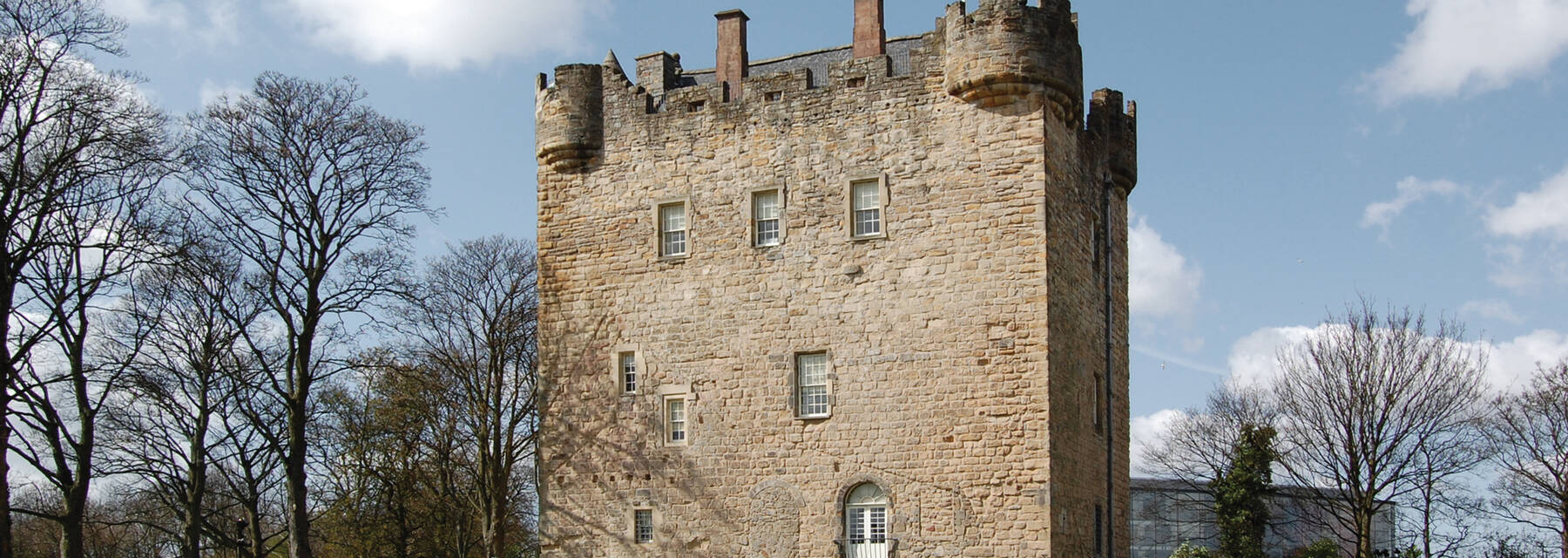Exterior of Alloa Tower surrounded by bare trees in winter