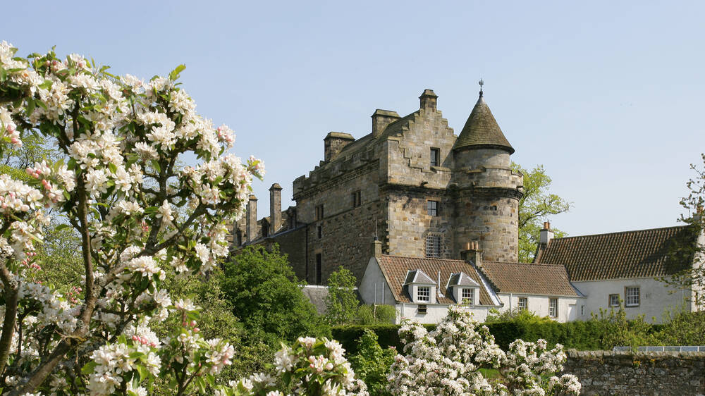 Falkland Palace with apple blossom in the foreground