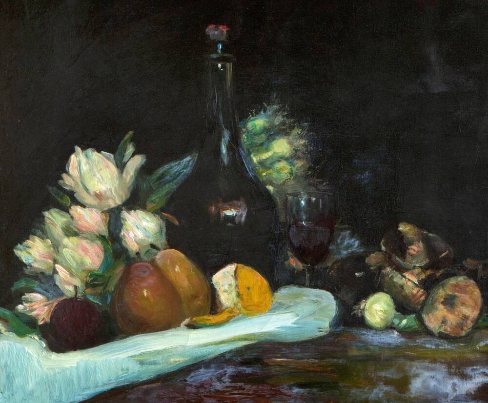 A still life painting of a collection of fruit and vegetables arranged on a table with a white cloth. A large decanter of wine stands at the centre, with a glass poured beside it. A bunch of white flowers lies in the background.