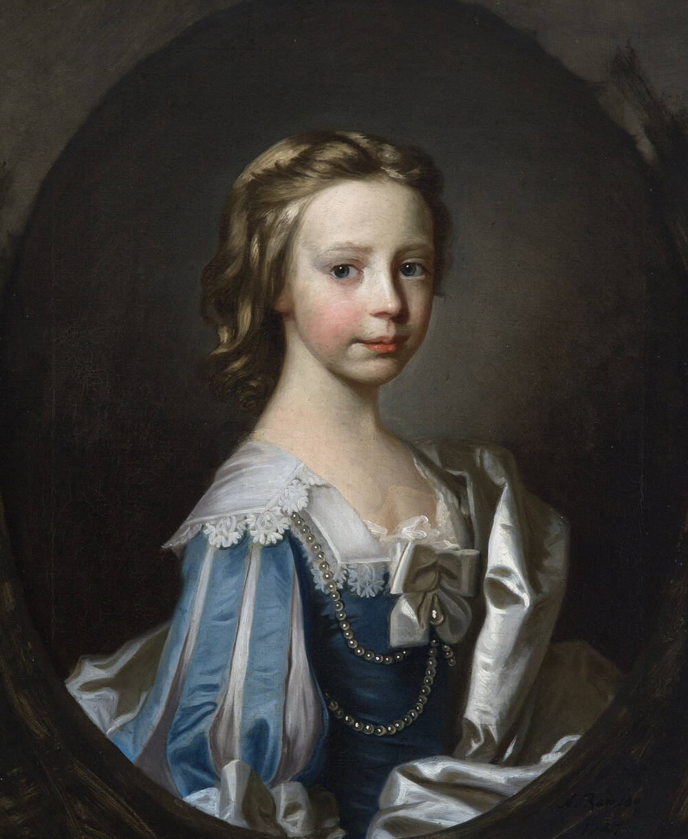 An oval half portrait of a young girl dressed in a formal blue dress, with pearl decoration.