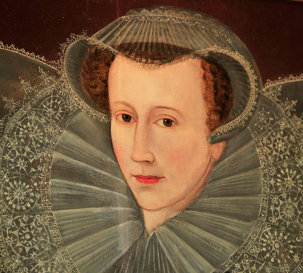 A portrait of ​Mary, Queen of Scots​, who wears a large ruff and small cap, almost covering her red hair.