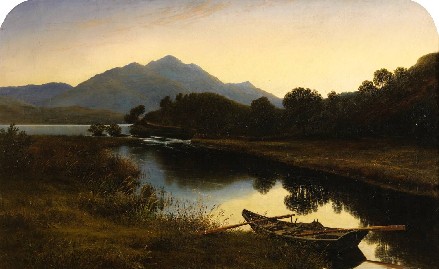 An oil painting of a rowing boat moored at the side of a loch. It is sunset. There are mountains on the far side of the loch. Reeds and long grass grow along the banks.