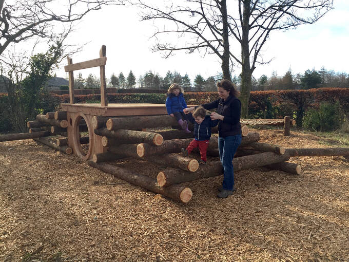 A family having fun in the Geilston Garden ‘Hobbit hole’ play area