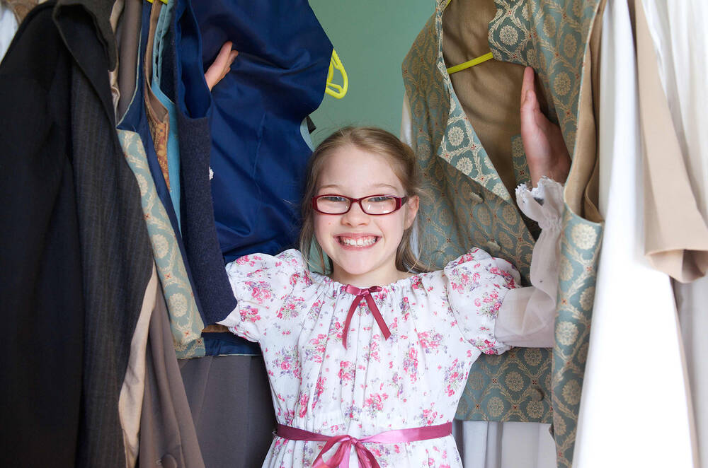 A young girl dresses up in replica costume in The Georgian House's Activity Room