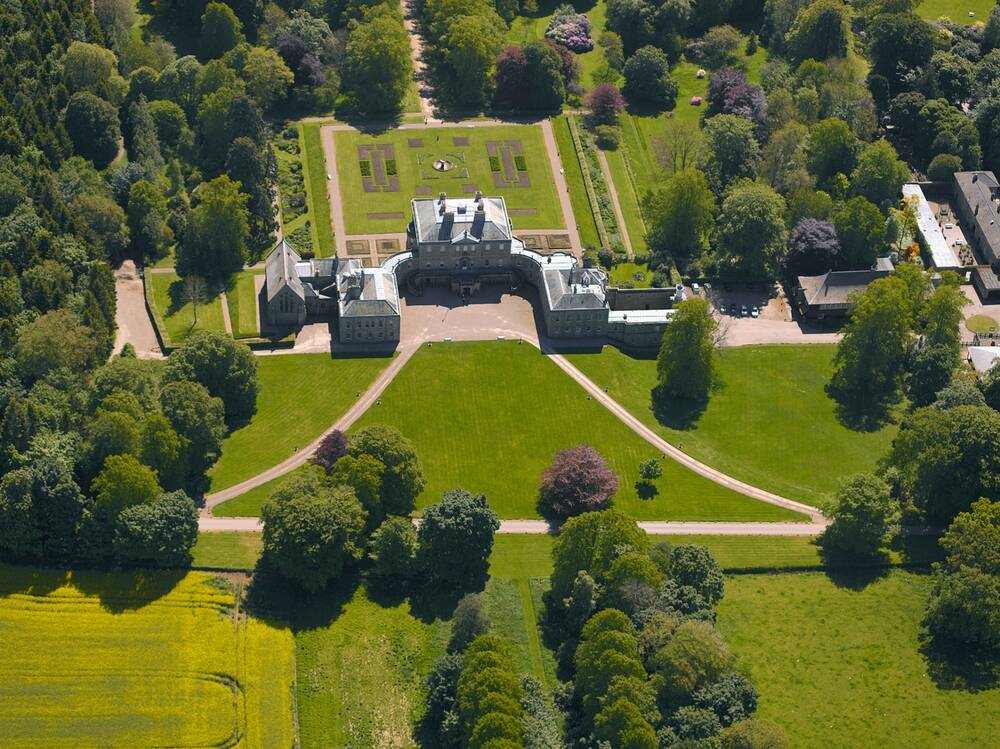 Aerial view of country house, set in parkland