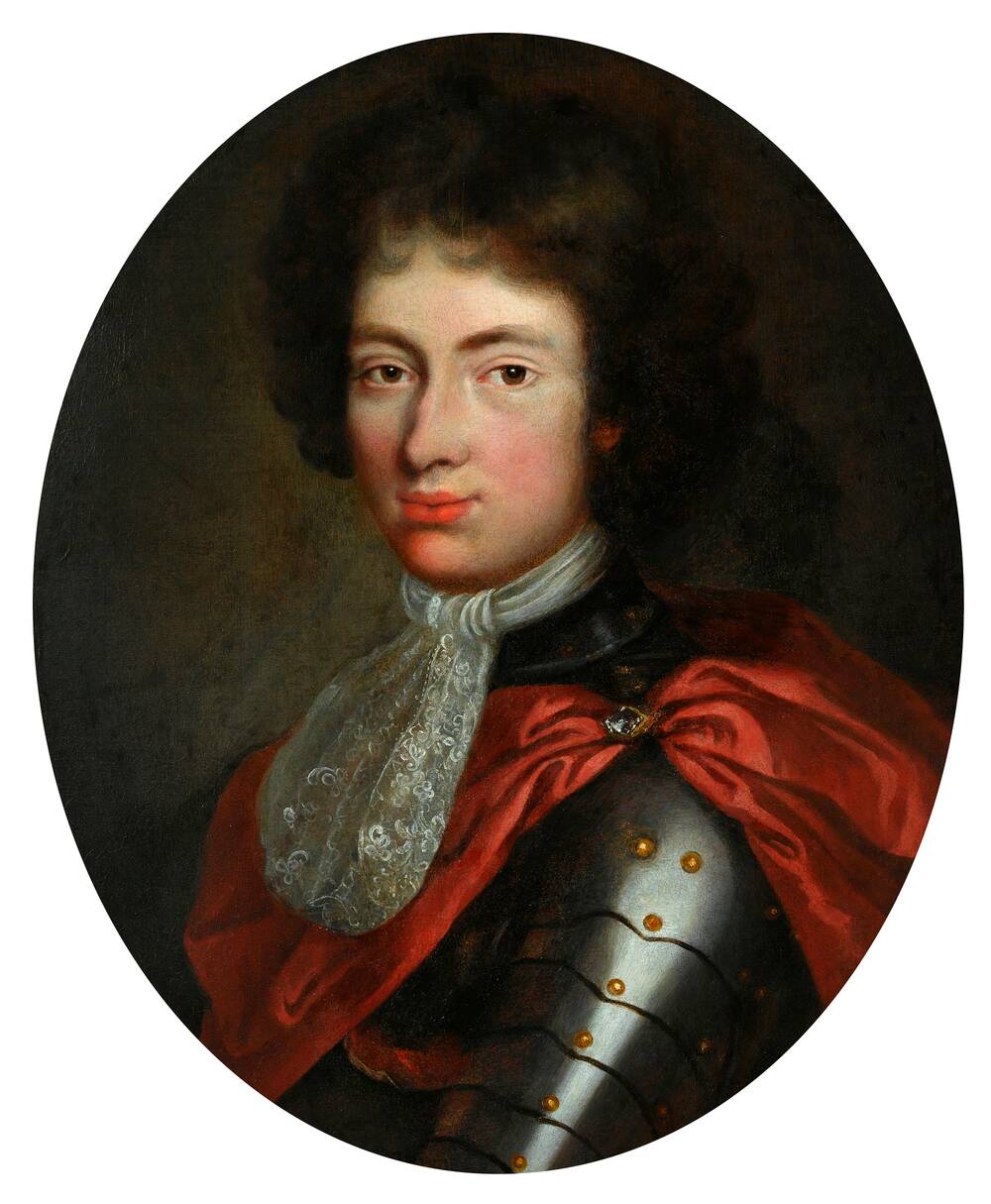 A half-portrait of a young 17th-century man, with dark curly hair. He wears fitted armour with a red satin cape over the top. He also has a lacy neck tie.