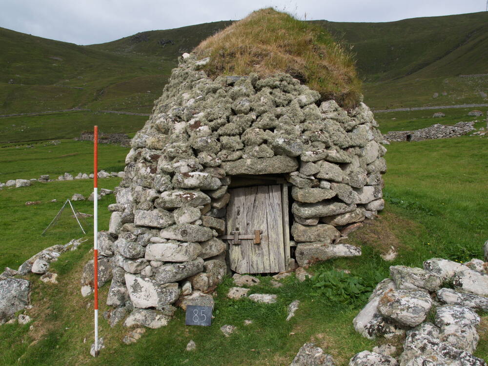 A stone structure with turf roof 