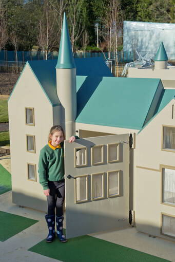 Schoolgirl playing in the mini Brodie castle