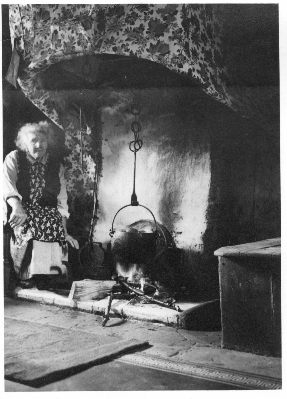 Lizzie Robertson by the chimney in the kitchen of Moirlanich Longhouse