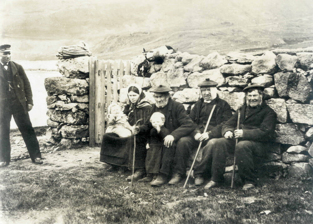 Glass plate negative of St Kildans posed for a tourist photo