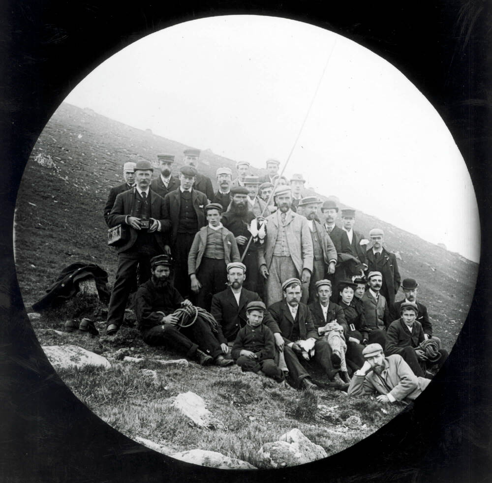 Glass plate negative of tourists posing with St Kildans