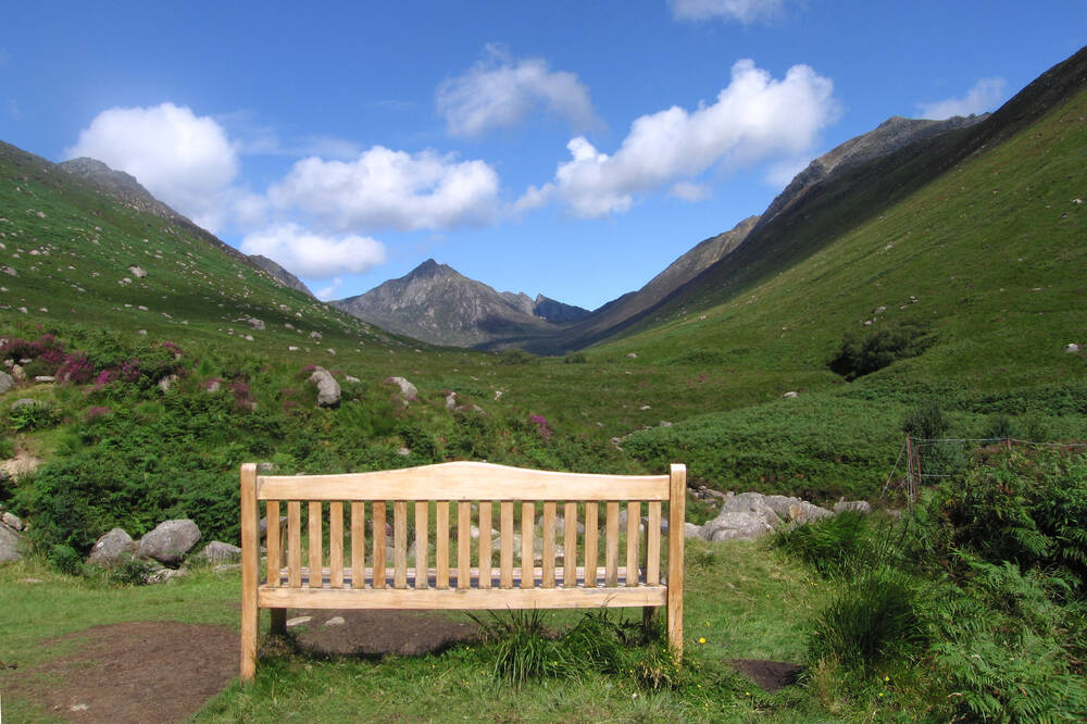 A bench with Goatfell in the background