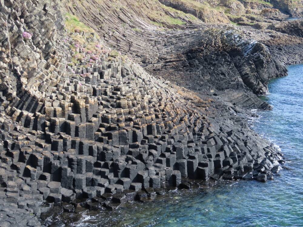 The hexagonal basalt rock formations on Staffa. They run into the sea.