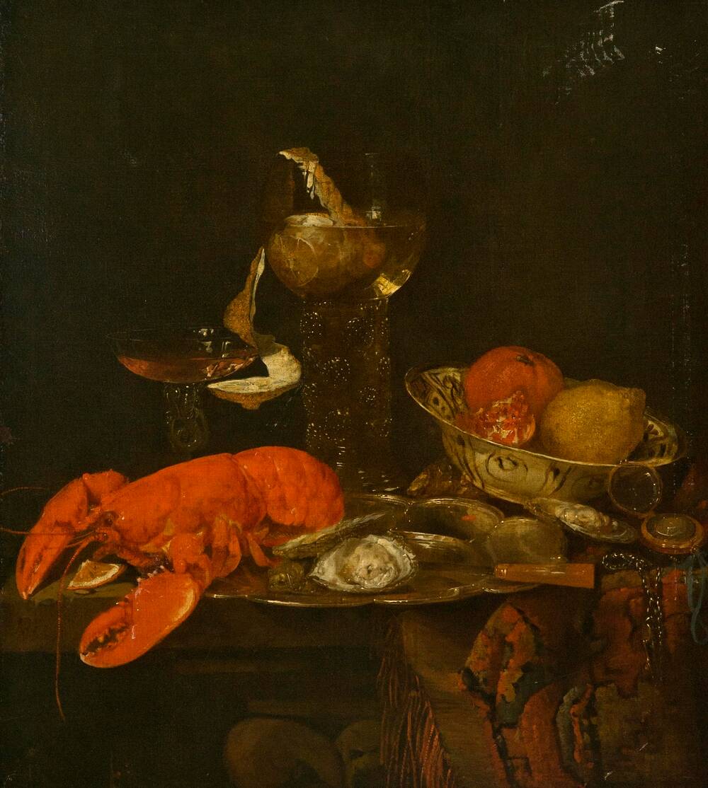 A still life oil painting of a table of rich food. A bright red lobster lies beside a plate of oysters in their shells. A pomegranate and other citrus fruit lie in a bowl behind. A couple of tall and elaborate drinking glasses stand on the table too.