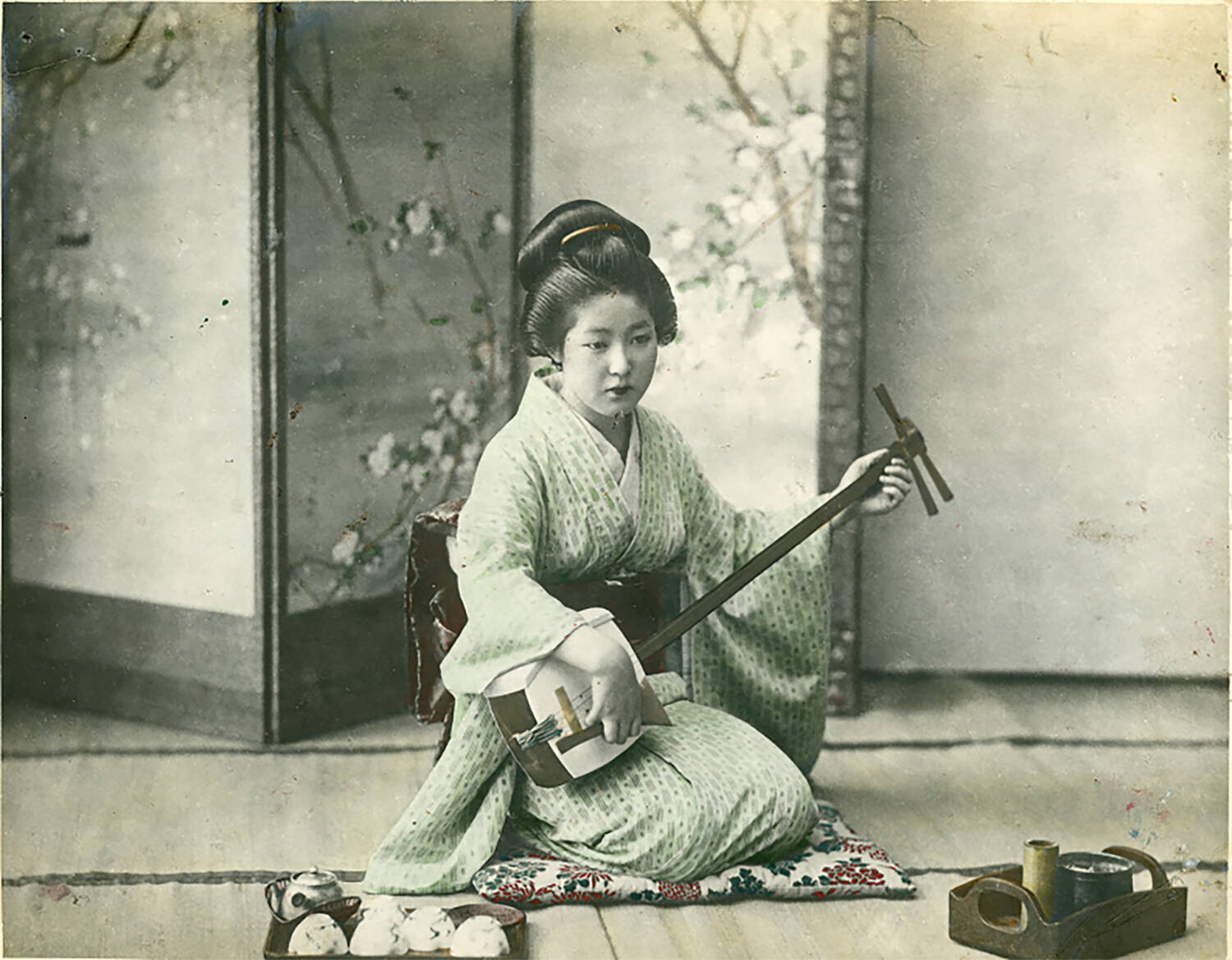 Shashin print of a woman playing a shamisen, by an unknown commercial photograph