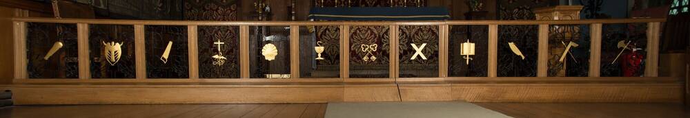 An altar rail for a chapel, with different designs between the rails.