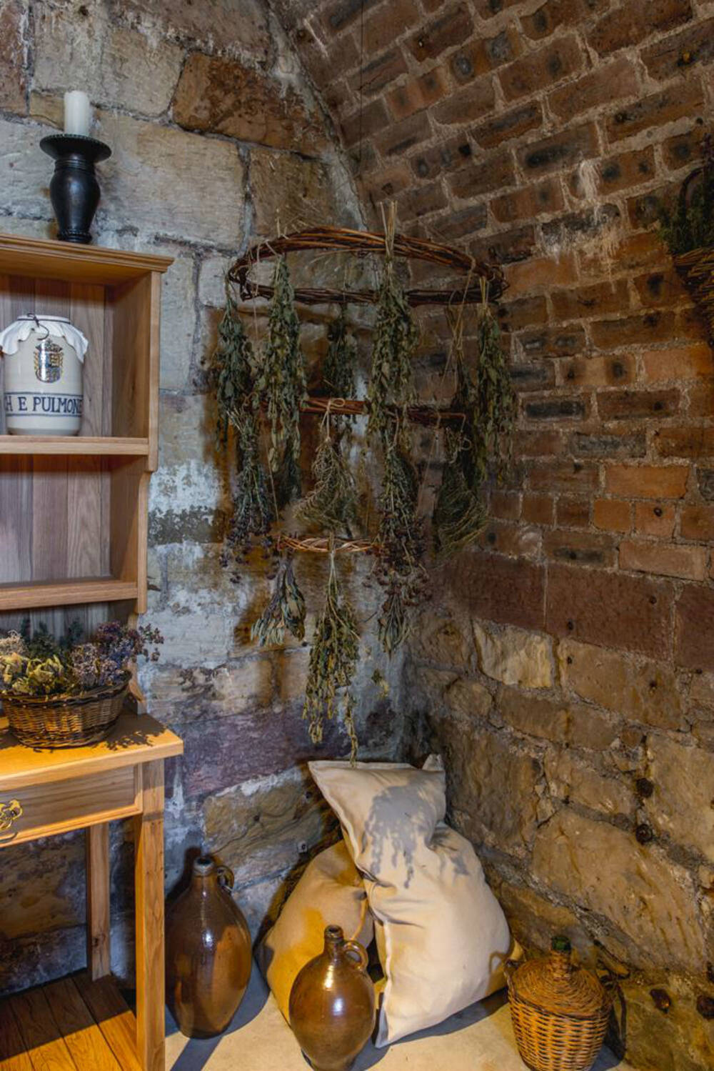 The apothecary has been filled with dried herbs in baskets and willow hangings