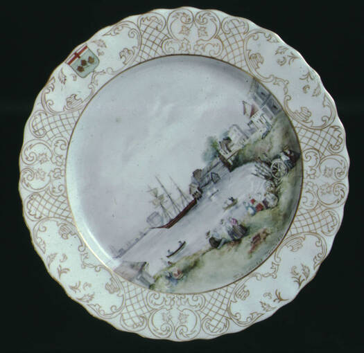 Round plate with a painted scene of boats on water