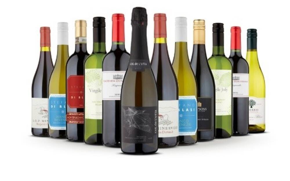 Twelve bottles of wine laid out in a chevron shape. The bottles are all different.