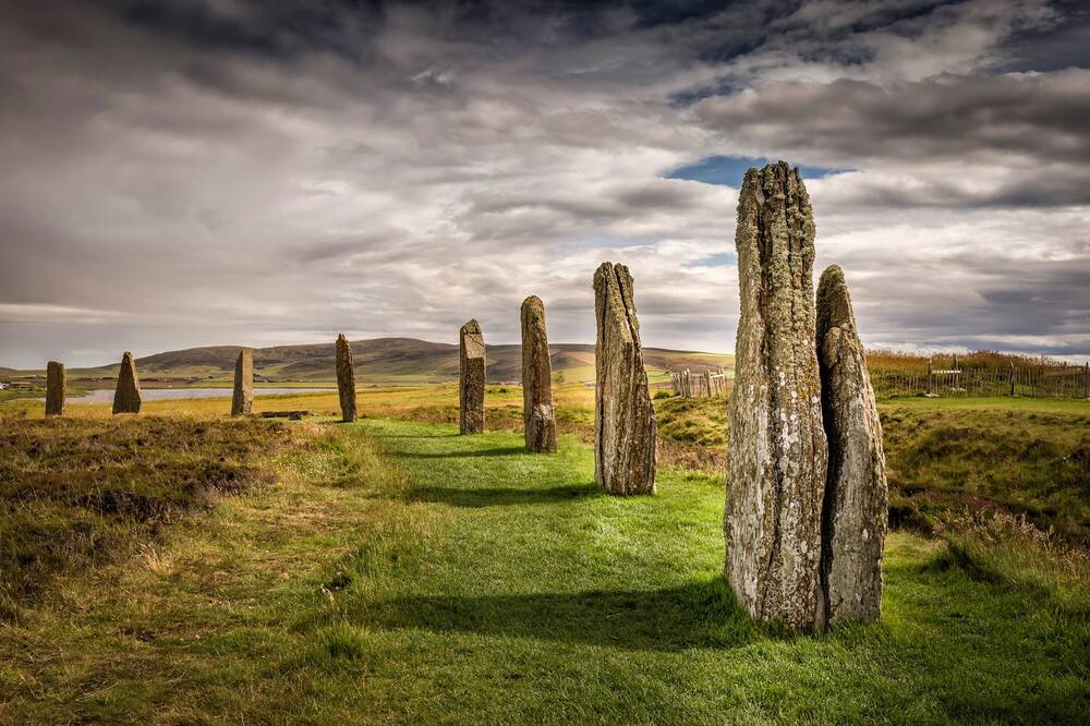 The UNESCO World Heritage Site of The Ring of Brodgar, Orkney - a circle of large standing stones under a moody sky.